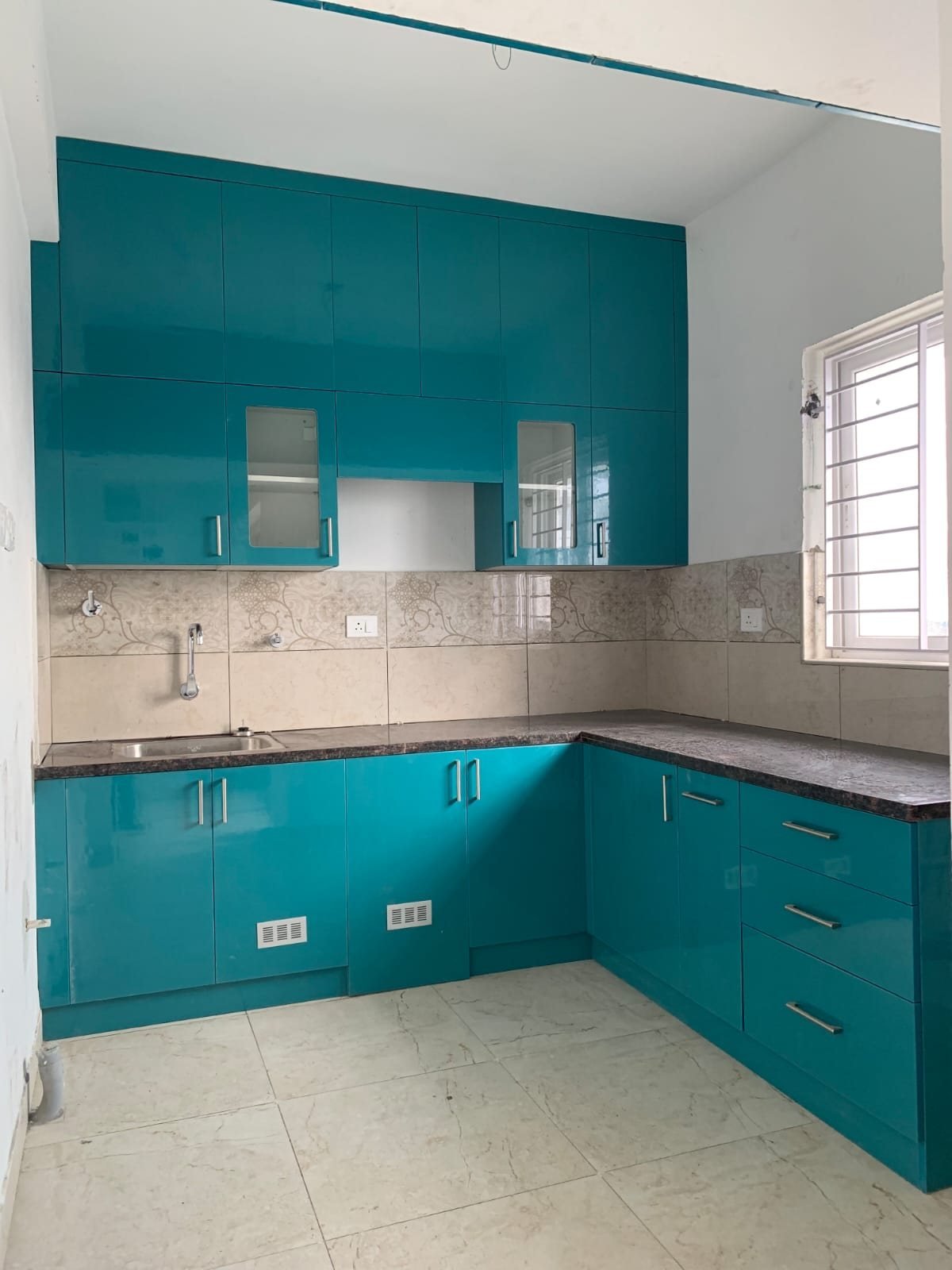 High-gloss teal modular kitchen